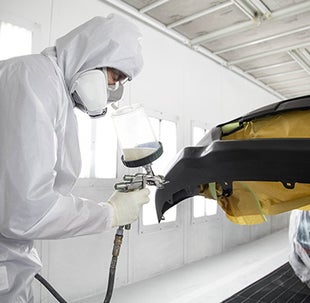 Collision Center Technician Painting a Vehicle | Deacon Jones Toyota in Clinton NC